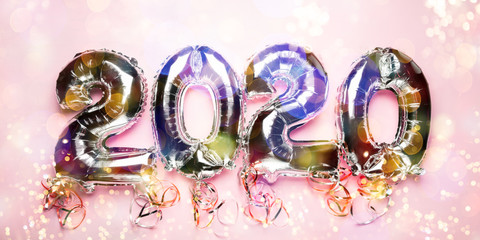 Balloon Bunting for celebration of New Year 2020 made from Silver Number Balloons. Holiday Party Decoration or postcard concept with top view and copy space. Banner size