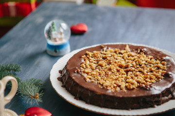 Traditional homemade cake with dried fruits and nuts Gluten free christmas nut cake on a gray table with christmas decorations