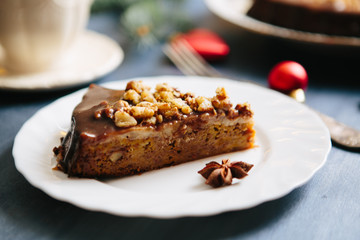 Christmas fruit cake on a gray background Gluten free christmas nut cake on a gray table with christmas decorations
