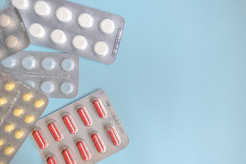 Tablets in packs. Tablets on a light background. Different types of pills