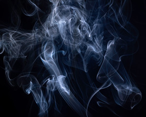 A close up macro photo of incense smoke lit by a blue flash to create a moody glow overlay