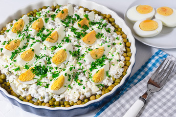 Salted herring in a cream sauce with apple, onion, peas and egg