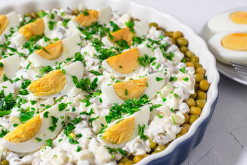 Salted herring in a cream sauce with apple, onion, peas and egg