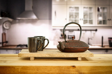 Kettle on wooden table and free space for your decoration.