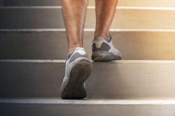 Runner feet running on stairs close up on shoe