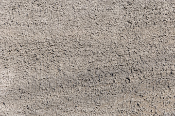 Surface texture of ragged gray concrete wall for background