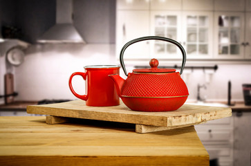 Kettle on wooden table and free space for your decoration.