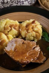 Braised pork neck in own sauce. Shallow depth of field.