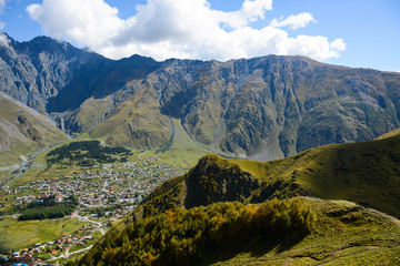 Naklejka premium Mountain view from Gergeti Trinity Church (Tsminda Sameba), Holy Trinity Church near Stepantsminda village (Kazbegi) in Georgia
