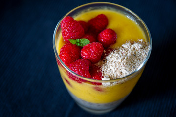 Chia pudding and Mango smoothie with raspberry and granola topping