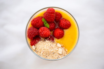 Chia pudding and Mango smoothie with raspberry and granola topping