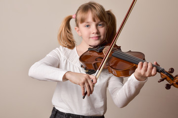 Girl happy looking straight ahead playing violin