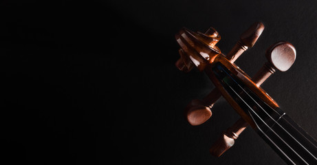 Violin pegbox on dark background top view © Davizro Photography