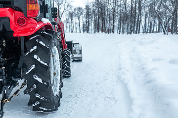 snow tractor rear wheel close-up on a winter park background