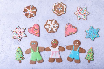 Gingerbread men and figures. Traditional New Year and Christmas homemade cookies. Christmas background. Selective focus, close up.