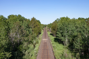 Fototapeta na wymiar Overhead View of Empty Tracks Through Green Countryside