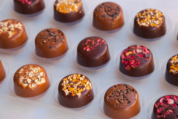 Assortiment of bonbons. Homemade chocolate with dry berries, dark chocolate and nuts.