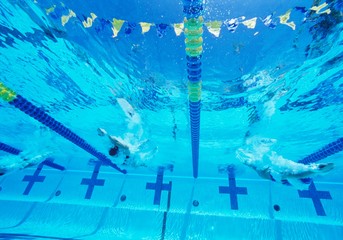 Underwater view of professional participants racing in pool
