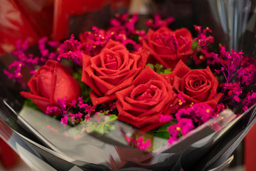 bouquet of Red rose flower in plastic wrap as valentine background