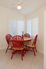 Wooden dining table with red chairs