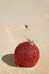 christmas ball on the sand of the beach