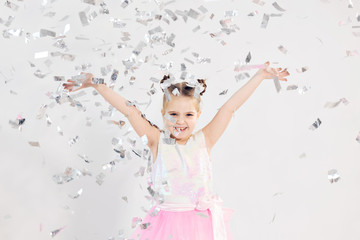 Obraz na płótnie Canvas Party, holidays, birthday, new year and celebration concept - Cute child throwing confetti.