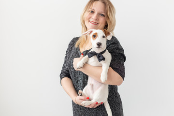 Pets and animal concept - Pretty woman with puppy Jack Russell Terrier on white background with copyspace