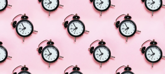 Retro alarm clocks on pastel background.