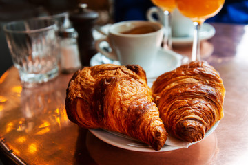 Breakfast with coffee and croissants on table
