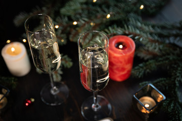 Christmas tree plate with green and black olives, cheese.Glasses of champagne