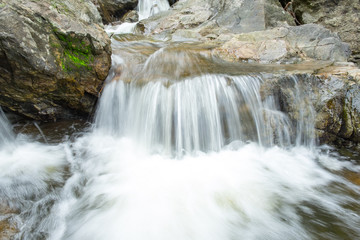 landscape photo. small waterfall Flowing through the channel rock. sarika waterfall in thailand.