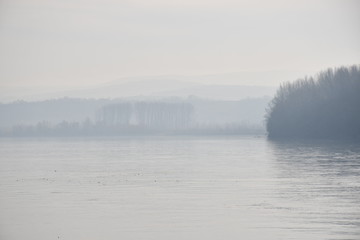 Foggy landscape of wide river 