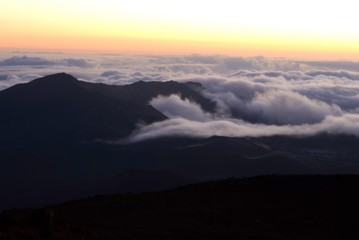 Maui sunrise from Haleakala with thick cloud layer below