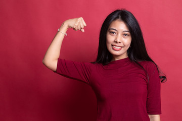 Beautiful young Asian woman flex bicep.