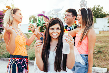 Brazilian Carnival. Group of Brazilian people celebrating the carnival party. The driver drinks water.