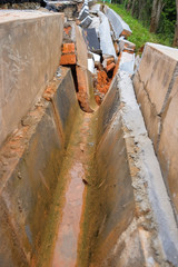 Drain damage. Soil erosion or landslide  in the slope  during  the rainy season at Muadzam Shah, Malaysia.