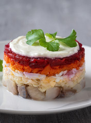 Traditional Russian salad herring under a fur coat, vintage wood background