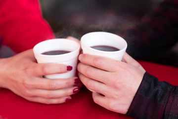 couple enjoying hot wine punch claret on christmas market