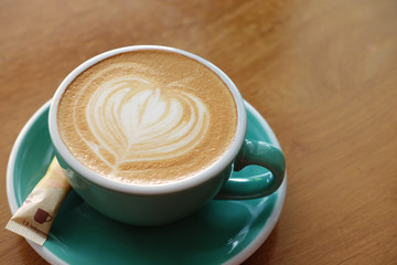 hot latte art with brown sugar in green cup