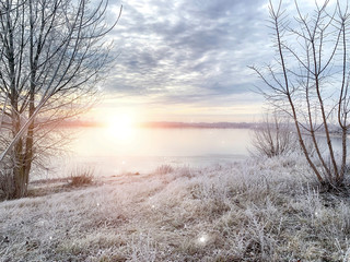 Winter landscape, landscape with a river and sunny sunset. Natural background, winter background.