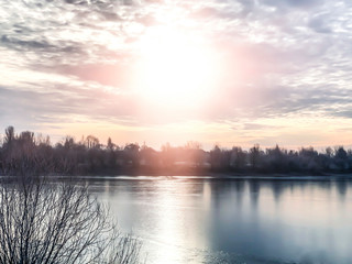 Winter landscape, landscape with a river and sunny sunset. Natural background, winter background.