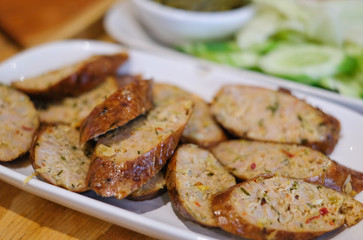 closeup spicy thai sausage on white dish