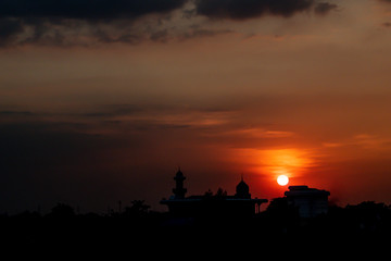 Concept of religion Islam. Silhouette of cultural building architecture over sunset sky background.