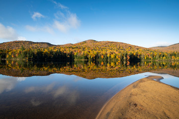 Beautiful reflections of autumn forest colors in the waters of a national park lake