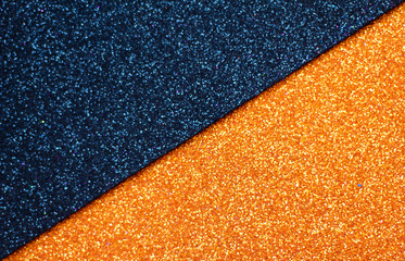 Black and orange glitter background, selective focus, free copy space