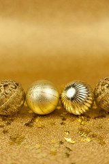 Christmas toys on a gold background. Christmas golden balls. Christmas motives. New Year.