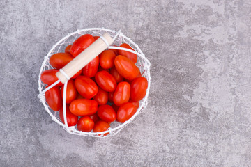 Tomatoes on a grey structured background