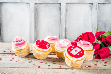 Valentine's day greeting card. Sweet Valentine's creative dessert food. Homemade pink and red  delicious cupcakes with decor of Valentine day symbols