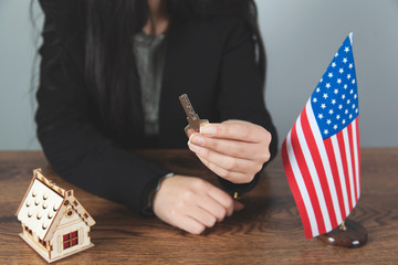 woman hand with house model and key