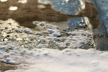 Snow melting under the sunlight. Selective focus.